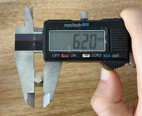 Digital caliper measuring 6.2mm rod, showcasing precision for Heavy Duty Six Point Two Millimeter Shelf Pegs.