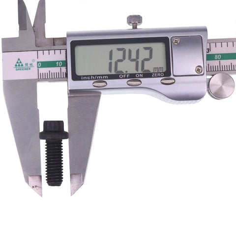 Close-up of a black pressure plate bolt measured with a digital caliper, display shows 12.42 mm