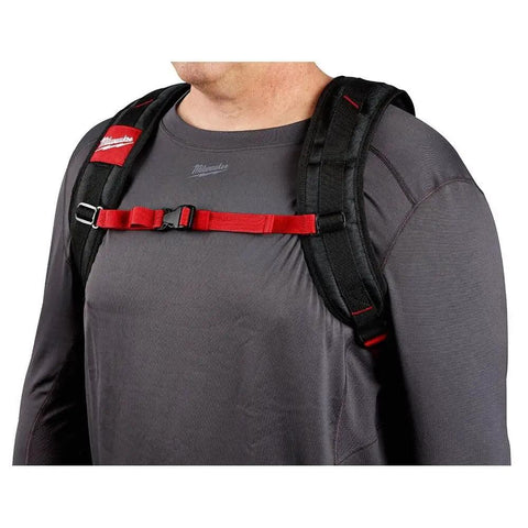 Badass Low Profile Backpack With Twenty Two Pockets And Heavy Load Bearing Harness For Tradesmen Ballistic Canvas Build harness detail showing padded straps on a user