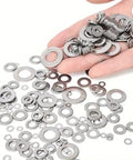 180 Pcs Stainless Steel Flat Washers Set For Screws And Bolts 304 Grade Assorted Sizes scattered on surface and hand