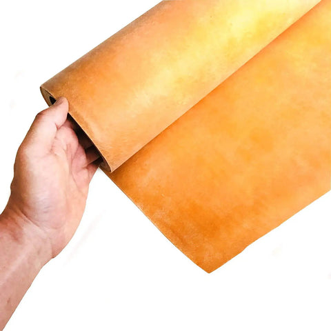 Hand holding beige polyethylene waterproofing membrane for bathrooms and showers, direct tile installation on top, 108 sq ft roll