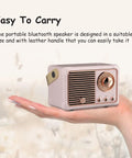 Retro Bluetooth Speaker Portable Wireless Speaker With Crystal Clear Stereo Sound And Rich Bass Pink Color held in hand