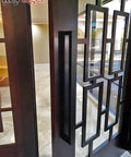 24 Inch Back To Back Modern Stainless Steel Door Handle Set In Matte Black Finish For Interior And Exterior Doors, installed on glass door.