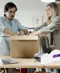 Water Activated Packing Tape Dispenser With Stainless Steel Cutter Manual Box Sealing Tool For Cartons Durable No Fuss Workhorse For Shipping And Moving Supplies on desk beside packed box