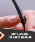 Close-up of person holding frame of anti fog and scratch resistant safety glasses for construction pros and everyday workers on the job.