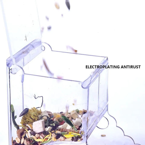 Clear Acrylic Automatic Pet Food Dispenser 300ml for Small Animals and Birds, open with scattered food inside.
