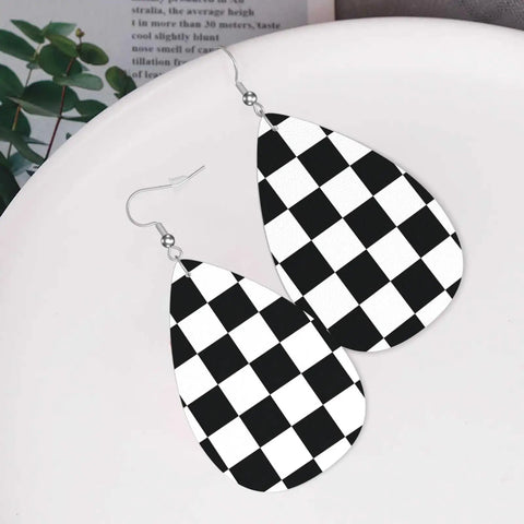 Black And White Checkerboard Teardrop Leather Earrings For Women, Faux PVC Silver Plated Hooks, visible on a plate.