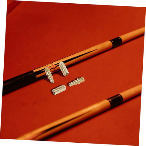 Heavy Duty Copper Pool Cue Extension Screws Four Pack on billiard table near pool cues for cue repairs.