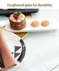 Super Spacious 40 Inch Lazy Susan Turntable For Kitchen Tables Crafted From Tough Tempered Glass with a cake and decorative sweets.