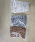 Replacement Mineral Shower Head Beads Set For Filtered Showers, 150g Pack Three Bags Of Beads On Table