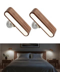 Legit Rechargeable Solid Wood Wall Sconces, Set Of Two Magnetic Bedside Reading Lights mounted above a bed, soft glow on.
