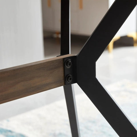 Close-up of the sturdy black metal base and walnut wood detail of the Modern Wood Top Dining Table With Sturdy Black Metal Base And Center Shelf For Kitchen Or Office With Rounded Child Safe Edges Heavy Duty Leveling Feet Straight Up Quality Design Ready For Your Daily Grind Or Casual Weekend Hangouts.