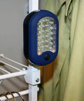 Magnetic LED Work Light Six Pack With 27 LED Lights And Swivel Hook attached to metal rack in closet, blue casing, side view