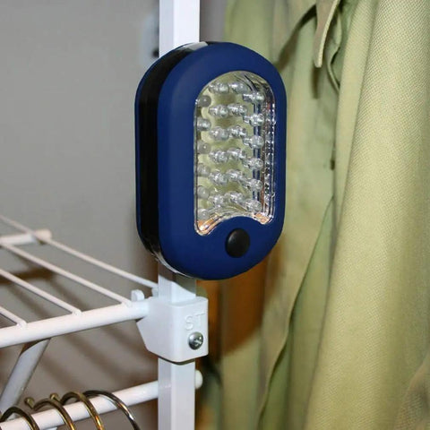 Magnetic LED Work Light Six Pack With 27 LED Lights And Swivel Hook attached to metal rack in closet, blue casing, side view