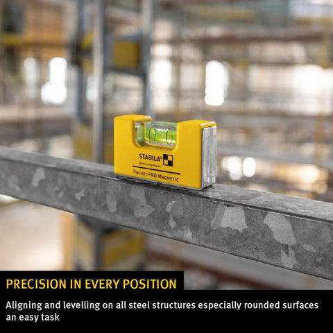 Magnetic Pocket Level Pro resting on steel beam for quick adjustments, mini aluminum frame, precision milled surfaces visible