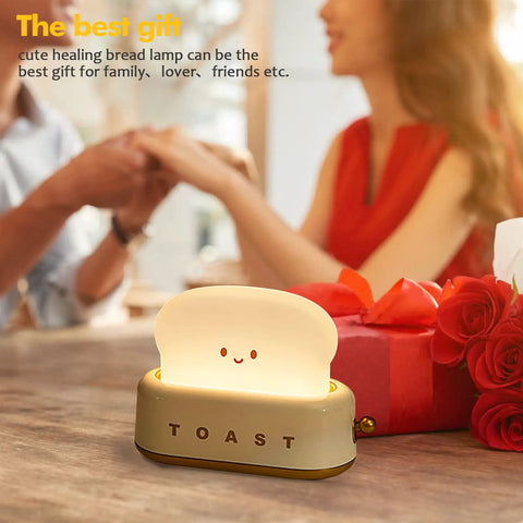 Toaster Shaped LED Table Lamp With Rechargeable Battery Nightstand Light With Timer Cute Toast Bread Bedroom Lamp For Kids Babies Boys And Girls Cozy Ambient Glow And Great Birthday Gift displayed on table