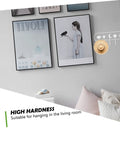 Heavy Duty Adhesive Hook Set That Stays Rock Solid No Sweat Install For Hanging Towels Coats Bags Keys Total Entryway Essential on a wall with framed art.