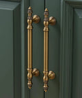 Twenty Pack Solid Brass Cabinet Pulls With Brushed Antique Brass Finish Six And Five Sixteenth Inch Hole Center handles on green cabinet