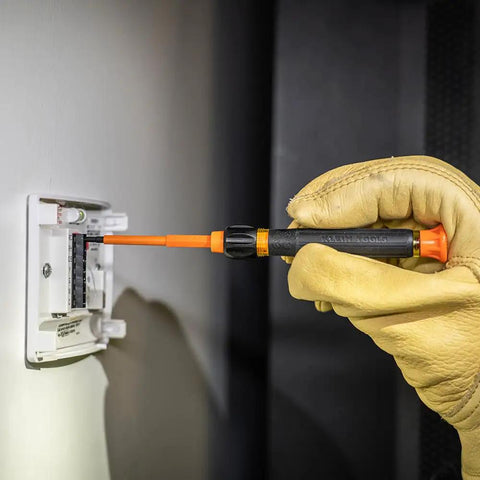 Using the 8-In-1 Insulated Screwdriver Set with 1000V rating on electrical panel, demonstrating Phillips blade in action.