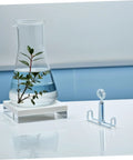 Beaker with plant next to Laboratory 25 Piece Flat Jaw Spring Clamp Set for Flexible Latex Tubes Rubber Hose Water Stop Clip.