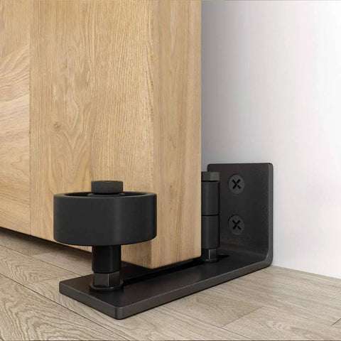 Flush Floor Sliding Barn Door Roller Guide Set With Wall Mounted Hardware installed on wooden door, black steel base