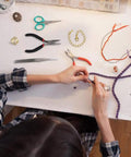 Person using All In One Jewelry Repair Kit With 1200 Jump Rings And Lobster Clasps, Pliers, Tweezers, And Opener, Silver And Gold Open Jump Rings Set for Necklace And Bracelet Making.