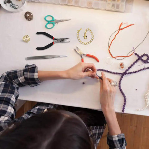 Person using All In One Jewelry Repair Kit With 1200 Jump Rings And Lobster Clasps, Pliers, Tweezers, And Opener, Silver And Gold Open Jump Rings Set for Necklace And Bracelet Making.