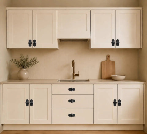 Four Pack Matte Black Cabinet Knobs With Sleek Backplates showcasing vintage floral petal details on beige kitchen cabinetry.