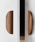 Oak Wood Oblique Angle 4.41 Inch Windbreaker Cabinet Door Handle In Antique Long Walnut Finish on white cabinet, side view