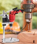 Universal Adjustable Bench Drill Stand Crafted With Slick Aluminum Alloy Plate For Rock Solid Hand Drill Clamping And Hella Smooth Workshop Precision Operation with hand drill in use.