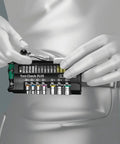 Person holding Tool Check Plus 39 Piece Mini Ratchet And Socket Set With Zyklop Mini Kraftform Grip for tight access.