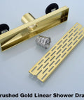 12 Inch Linear Shower Drain With Removable Brickwork Pattern Grate Adjustable Feet Hair Catcher Brushed Gold Finish Rectangular Floor Drain 2 Inch Outlet SUS 304 Stainless Steel