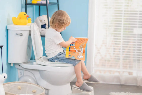 Child using round toilet seat with slow close and quick release easy clean plastic in white standard round size for family bathrooms.