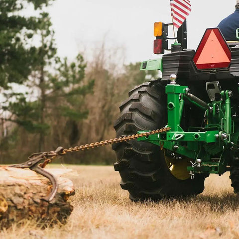 Dual Design Gooseneck Tractor Trailer Hitch With Hay Bale Spear Charcoal Frame Two Inch Receiver Mount And Two Five Sixteenth Inch Gooseneck Ball attached to tractor