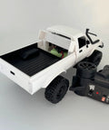 Back view of a white Rugged One Sixteenth Scale RC Rock Crawler Truck 4x4 with Realistic Interior and remote control