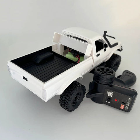 Back view of a white Rugged One Sixteenth Scale RC Rock Crawler Truck 4x4 with Realistic Interior and remote control