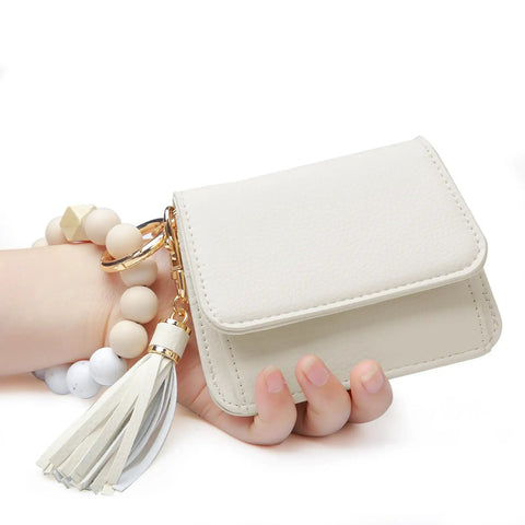 Hand holding RFID Keychain Wallet Wristlet For Women With Coin Pocket And ID Window Beaded Key Chain Wristlet Beige