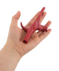Close-up of red fencing replacement grip and stable handle for foil in hand.