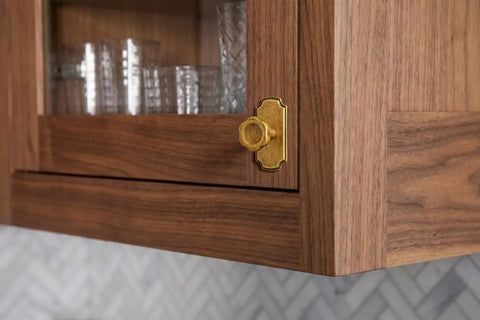Close-up of Antique Brass Cabinet Knobs With Backplate 6 Pack Solid Zinc Alloy single hole on wooden cabinet.