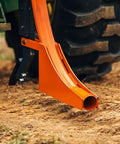 Close-up rear view of 3 Point Subsoiler With Pipe Layer For Cat 1 Tractors, Accepts 50mm Poly Pipe, against compact soil