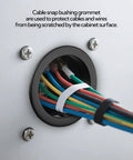 100-Piece Black One To Three Sixteenth Inch Cable Snap Bushing Grommet Set installed in cabinet hole with multicolor wires