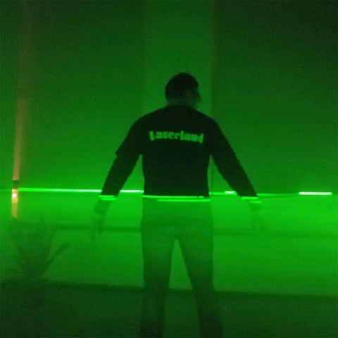Person with 532nm Green Laser Line Module Projector for Halloween lighting effects, beam through smoke, dark setting
