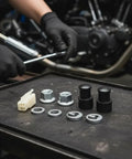 Must Have M12 EBike Hub Motor Axle Nut Kit With Front Lock Nut Lock Washer And Protective Cover For 12mm Shafts displayed on table