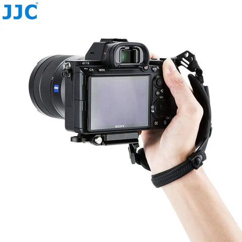 Hand holding camera with Pro Mirrorless Camera Hand Grip Strap With Arca Type Plate, Adjustable Length, Grippy No Slip Wrist Guard.