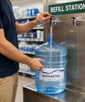 Filling a 5 Gallon BPA Free Water Bottle Reusable Jug With Large Capacity Polycarbonate Container at a refill station.