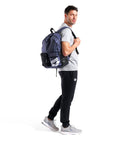 Man wearing Do It All Swim And Sports Backpack 30L Navy Blue For Men And Women Multisport Daypack With Top Loading Main Compartment