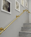 Heavy Duty Adjustable Round Tube Railing Kit For Decks And Stairs mounted on wall beside staircase for safety and support.