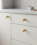Top Shelf Brushed Gold Cabinet Knobs Six Pack For Modern Kitchen Drawers And Dressers Crafted From Solid Zinc Alloy Ridge Tough Construction Quick Install Mounting on white cabinet.