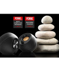 Pebble 2.0 USB Powered Desktop Speakers with Far Field Drivers and Passive Radiators in black next to stacked stones