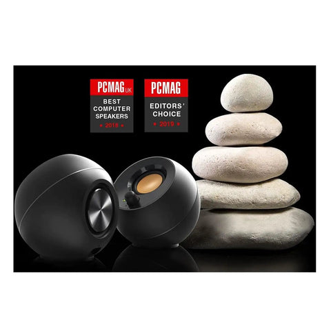 Pebble 2.0 USB Powered Desktop Speakers with Far Field Drivers and Passive Radiators in black next to stacked stones